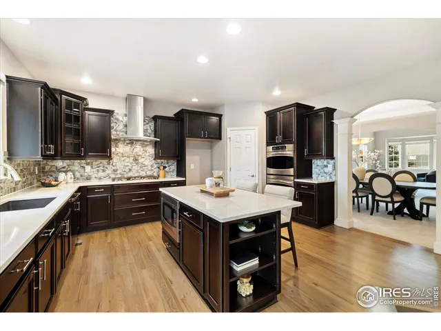 a kitchen with a sink a counter top stainless steel appliances and cabinets