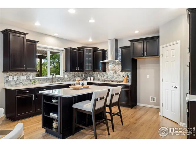 a kitchen with stainless steel appliances kitchen island granite countertop a sink and cabinets