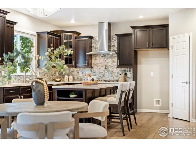 a kitchen with stainless steel appliances kitchen island granite countertop a refrigerator and a stove top oven