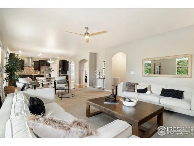 a living room with lots of furniture and view of kitchen