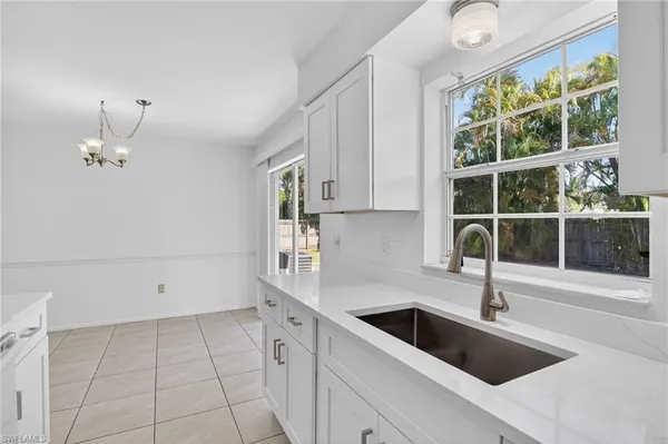 a kitchen with granite countertop a sink and a stove