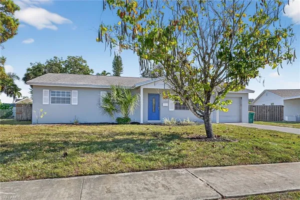 a house that has a tree in front of it