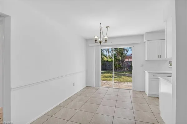 a view of an empty room with a kitchen