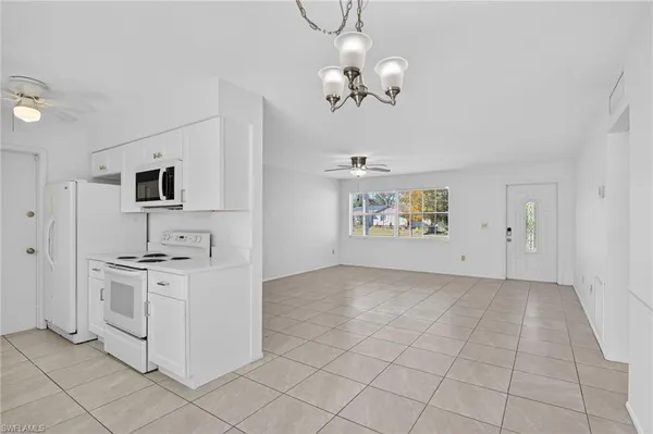 a view of a kitchen with cabinets and stainless steel appliances