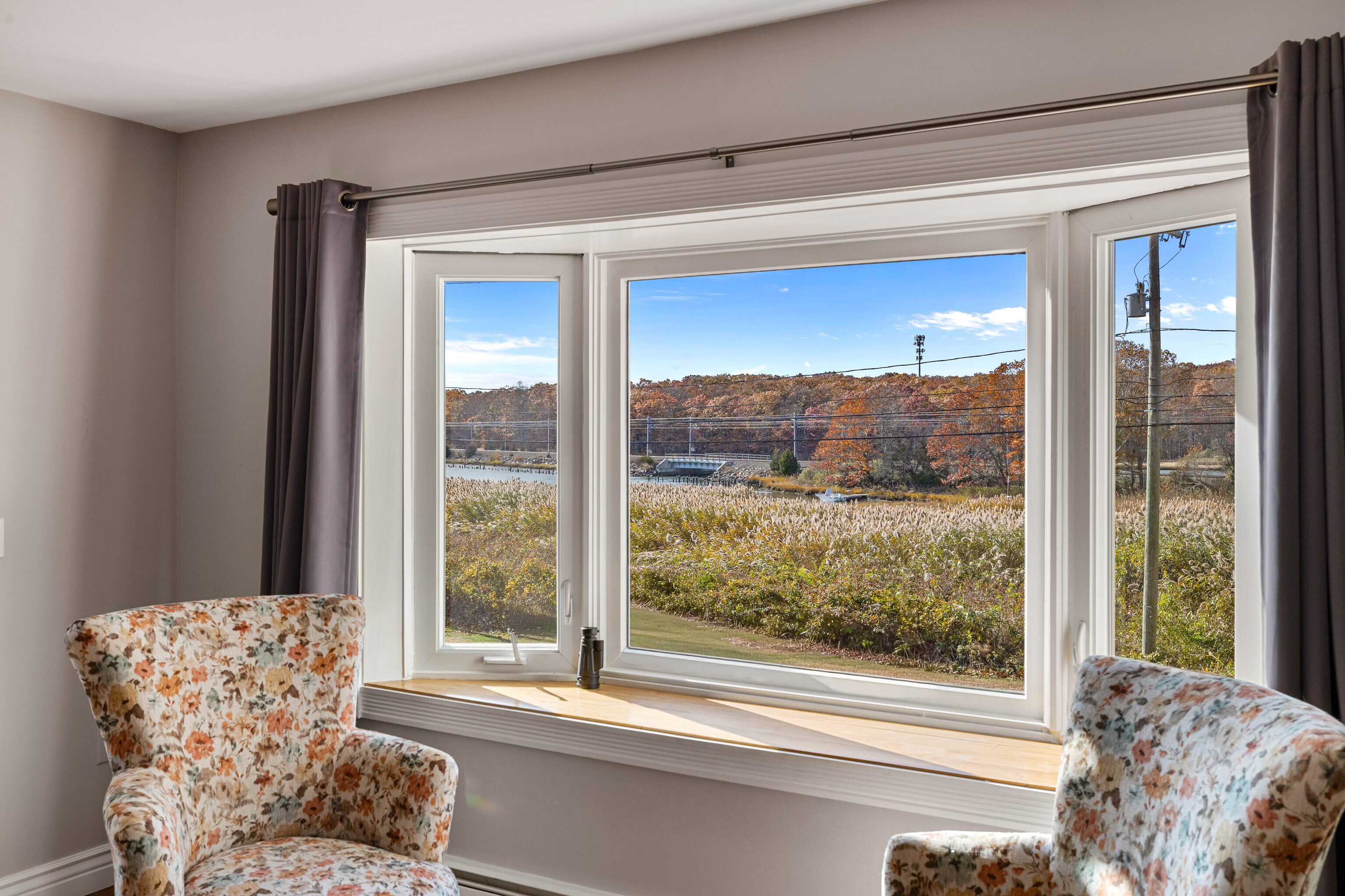 46 Old Black Point Road East Lyme, CT 06357 - Photo 12 of 40 a living room with a large window and a table