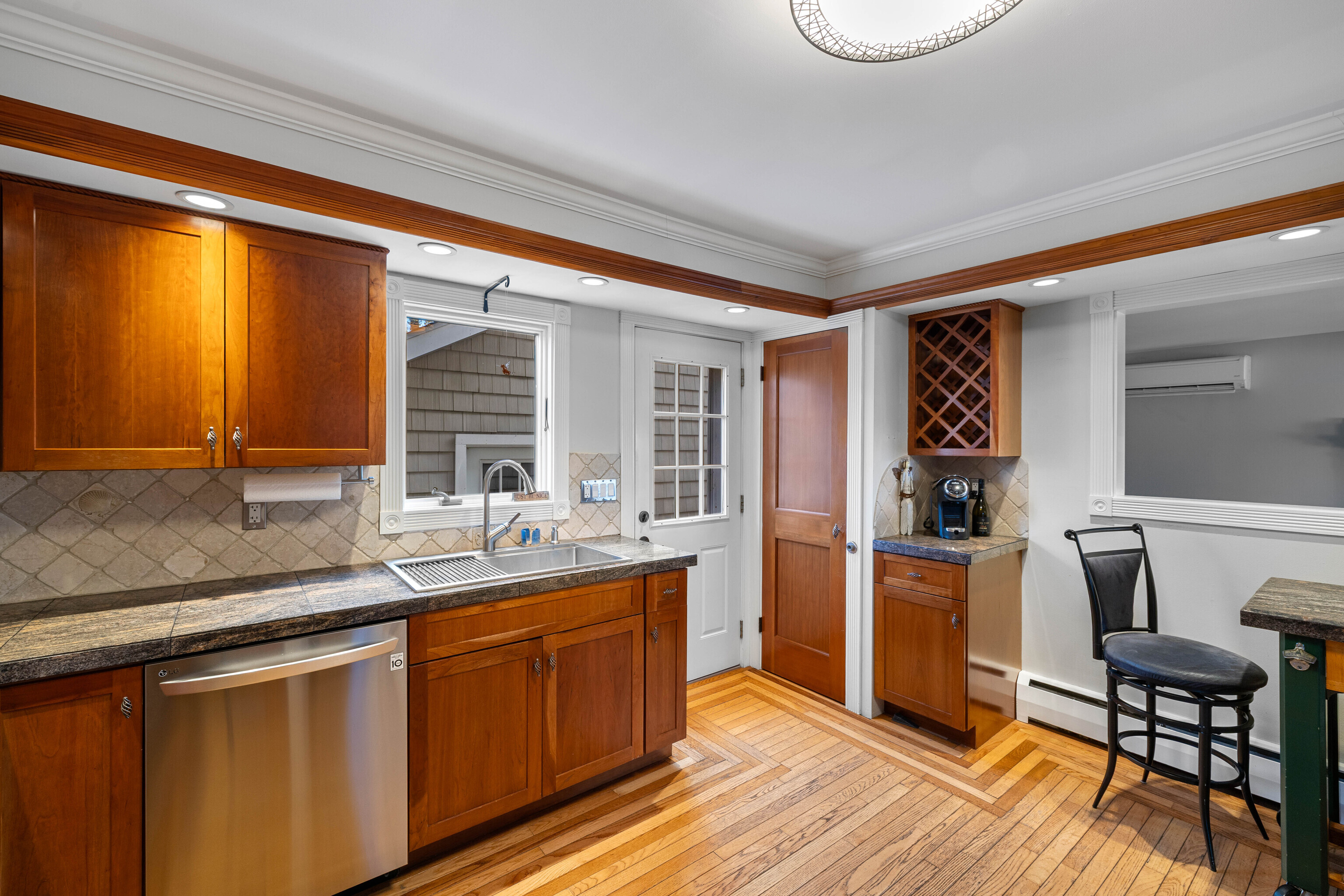 46 Old Black Point Road East Lyme, CT 06357 - Photo 18 of 40 a kitchen with a sink cabinets and wooden floor