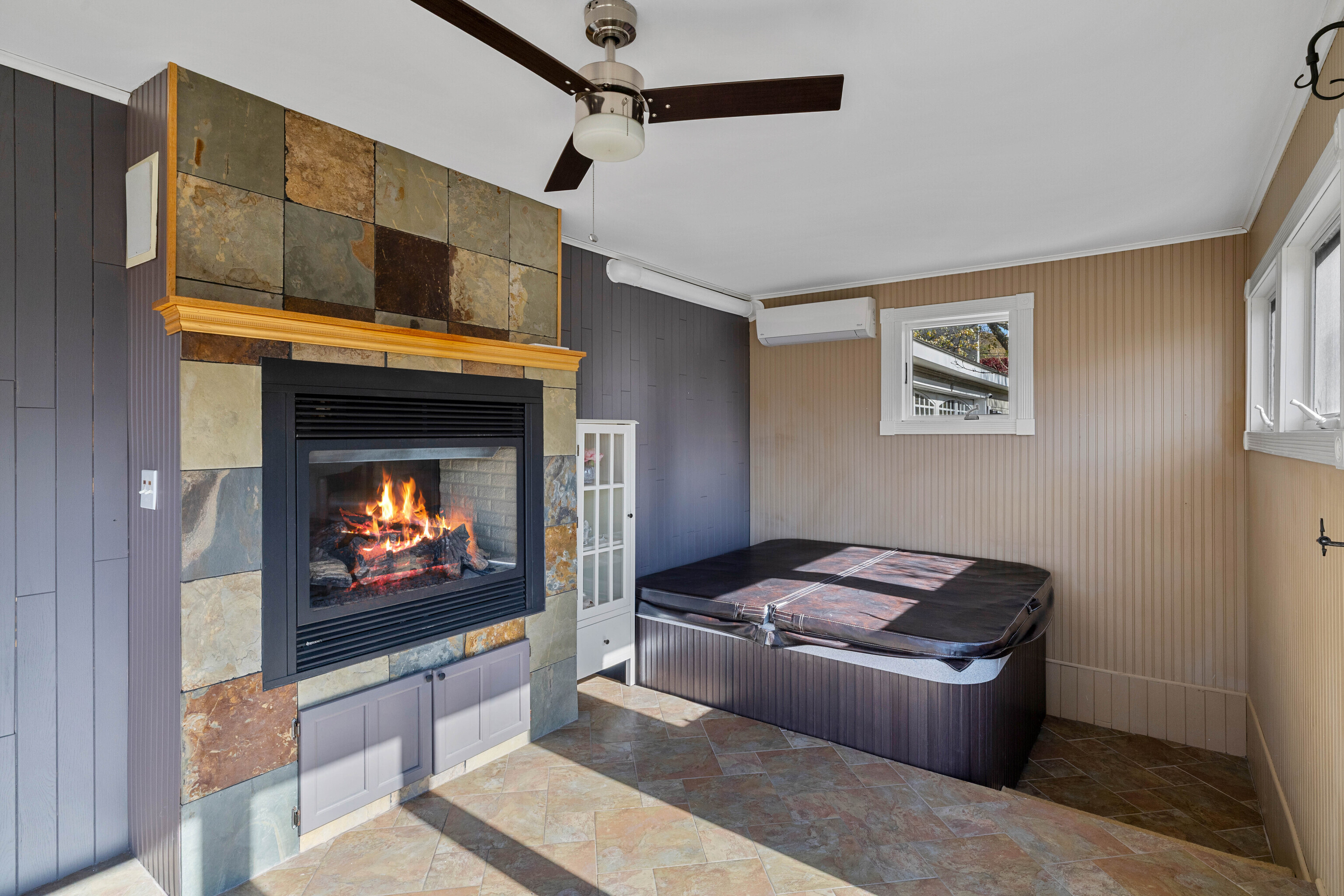 46 Old Black Point Road East Lyme, CT 06357 - Photo 20 of 40 a living room with fireplace furniture and a flat screen tv