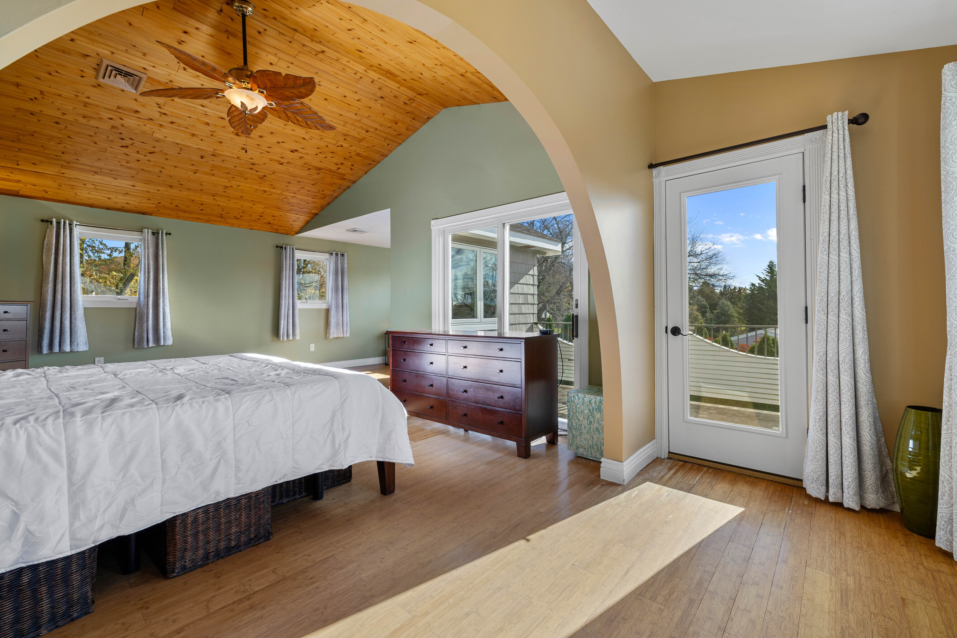 46 Old Black Point Road East Lyme, CT 06357 - Photo 36 of 40 a spacious bedroom with a bed and a chandelier