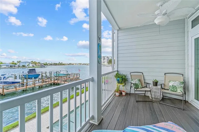 a view of a lake with couches and wooden floor