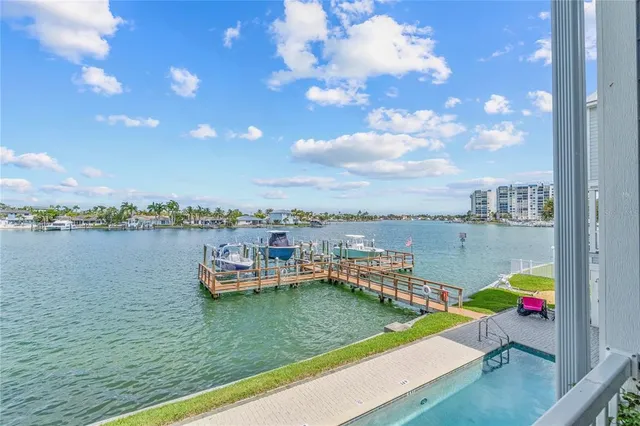 a kitchen with stainless steel appliances granite countertop a refrigerator oven a sink dishwasher and white cabinets with wooden floor