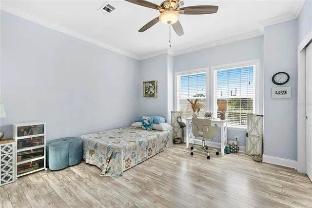 a bedroom with a bed and a chandelier
