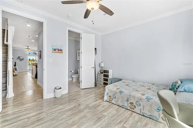 a view of a bedroom with a bed and wooden floor