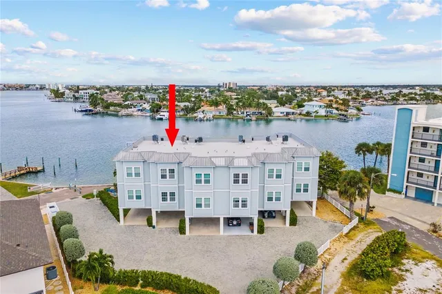 a view of roof deck with dining table and chairs