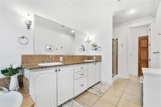 a bathroom with a tub sink and mirror