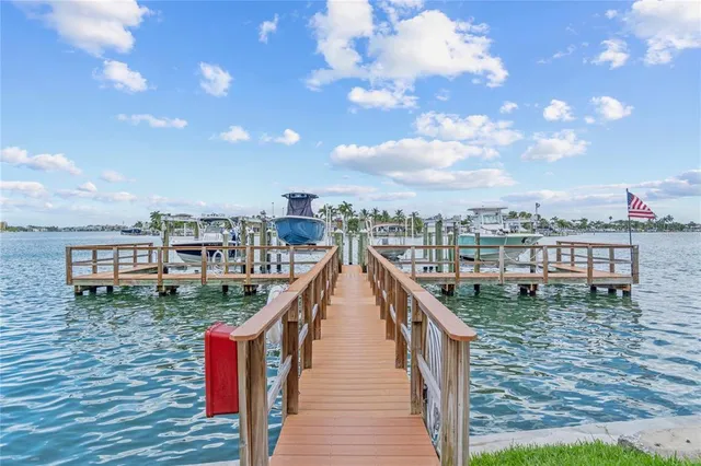an aerial view of a city with lots of residential buildings ocean and mountain view in back