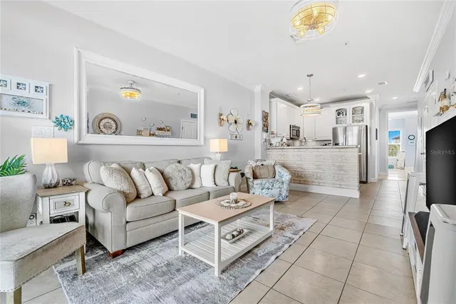 a living room with furniture and a chandelier