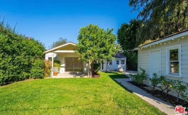 a view of a house with a yard porch and sitting area