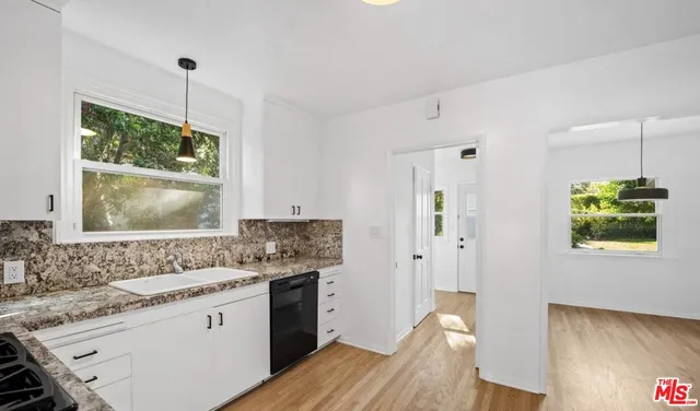 a kitchen with a sink stove and refrigerator