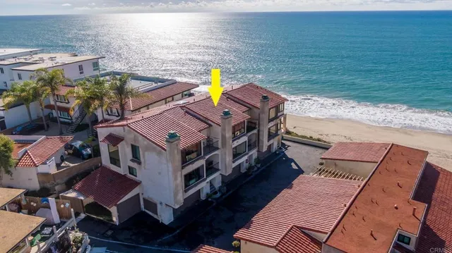 an aerial view of a house with a ocean view