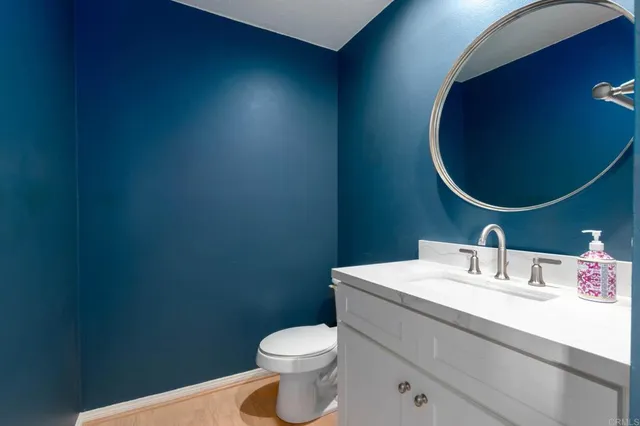 a bathroom with a sink toilet and mirror