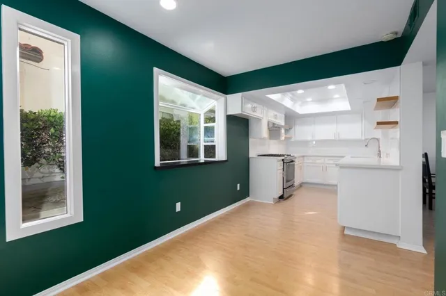 a view of a kitchen with a fridge and a window