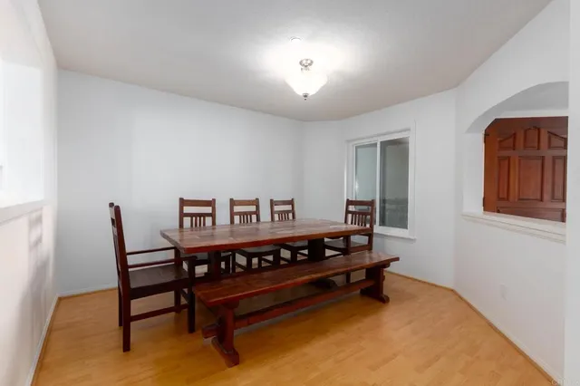 a view of a room with furniture and wooden floor