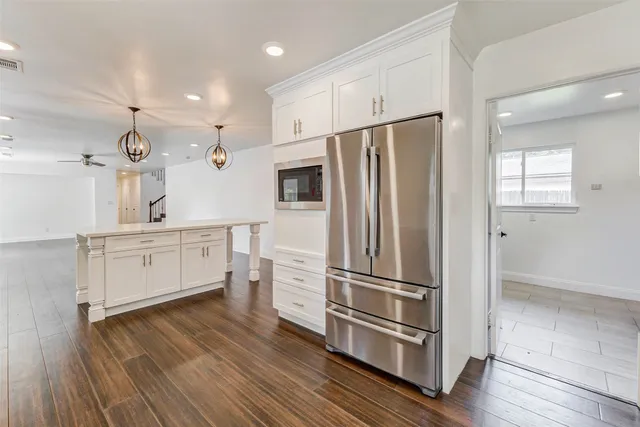 a kitchen with stainless steel appliances a refrigerator sink and cabinets