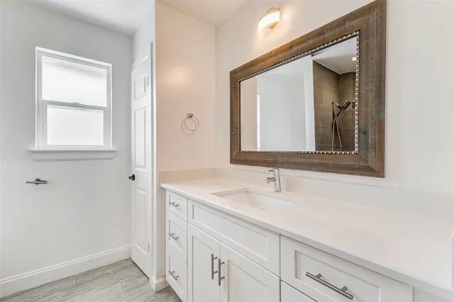 a bathroom with a sink and a mirror