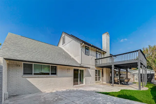 a view of a house with a yard and sitting area