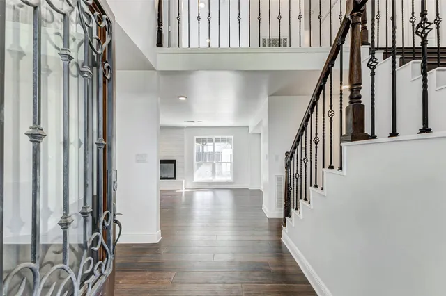 a view of an entryway with wooden floor and stairs