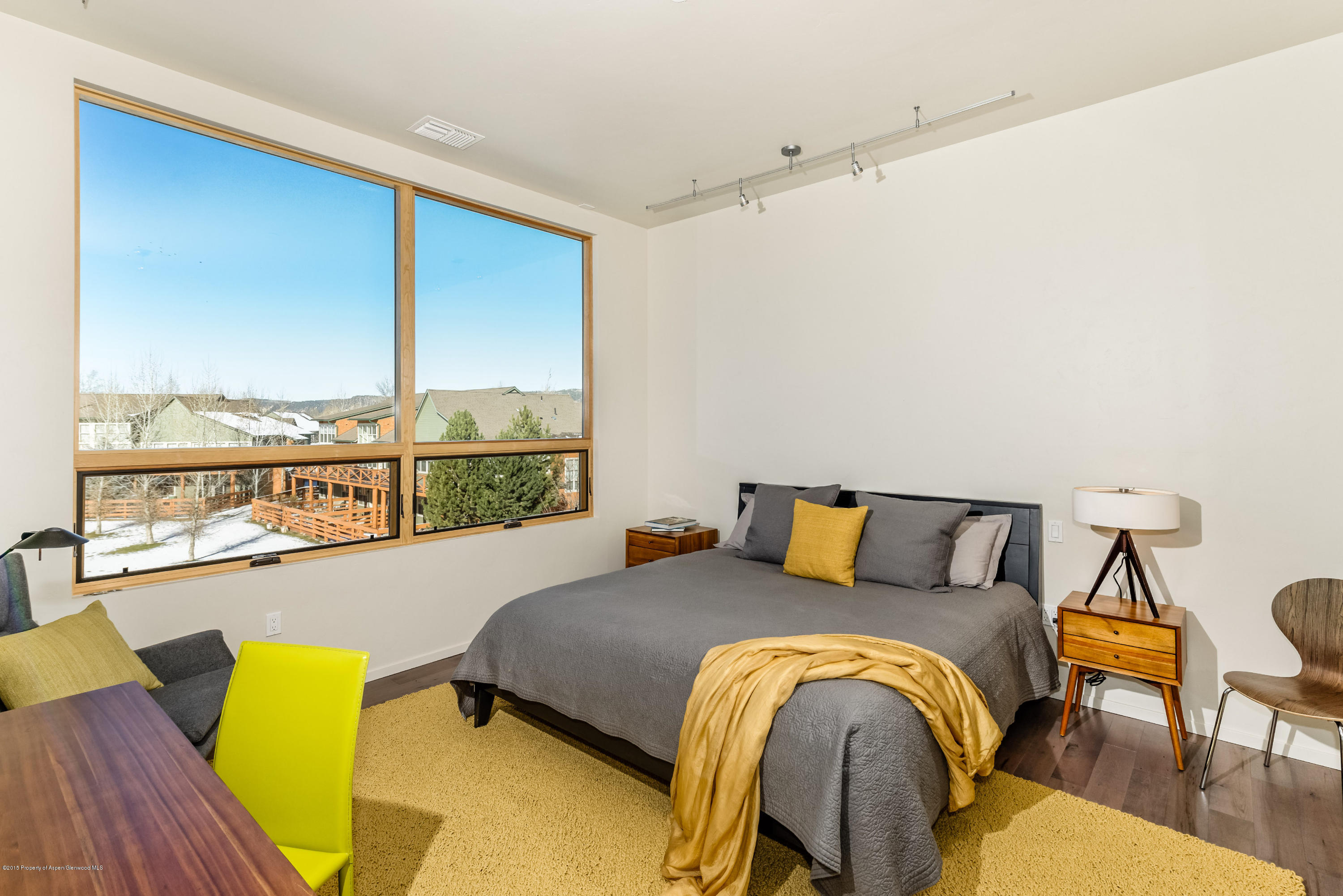 200 Evans Road, Unit 101 Basalt, CO 81621 - Photo 6 of 53 a bedroom with a bed and wooden floor