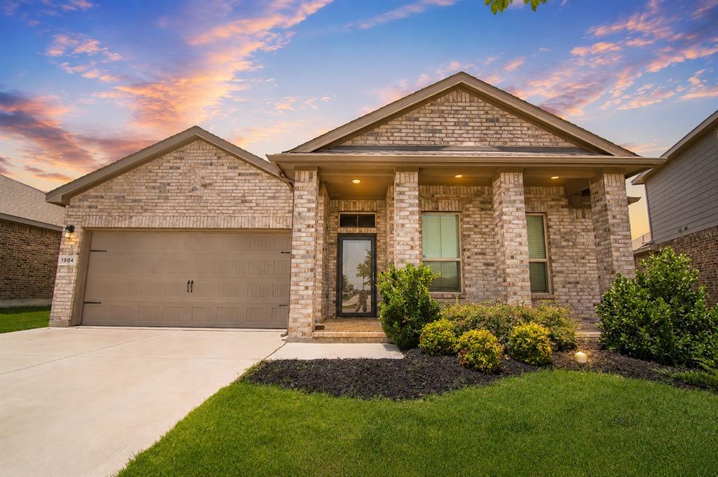 1804 Mensa Drive Haslet, TX 76052 - Photo 1 of 30 Brick exterior with a covered entry and columns