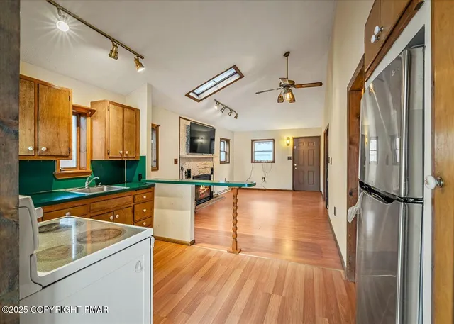 a view of a kitchen cabinets a sink and wooden floor