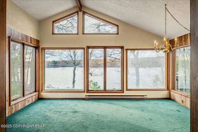 a view of a room that has a window and kitchen view