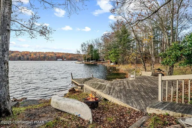 a view of a backyard with lawn chairs and iron fence