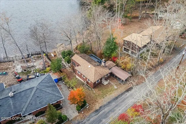 an aerial view of a house with a yard
