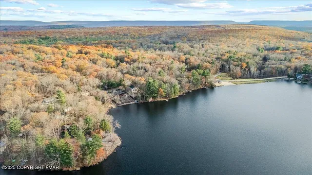 an aerial view of residential houses with outdoor space and river