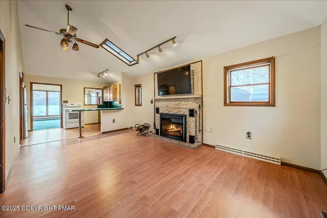 a view of a livingroom with an empty space and a fireplace
