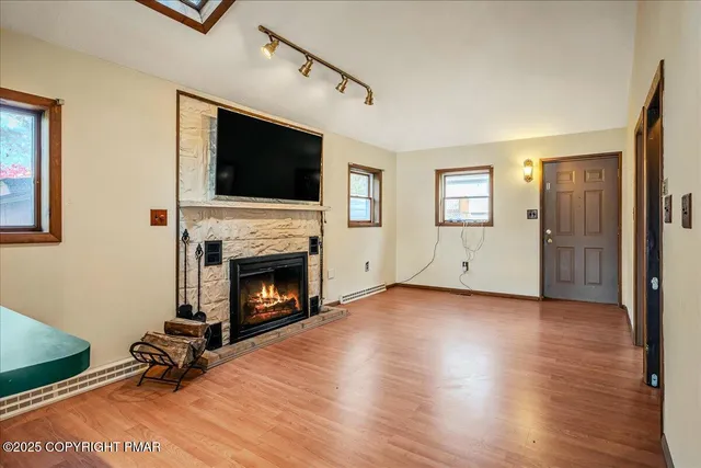 a view of a livingroom with a fireplace and window