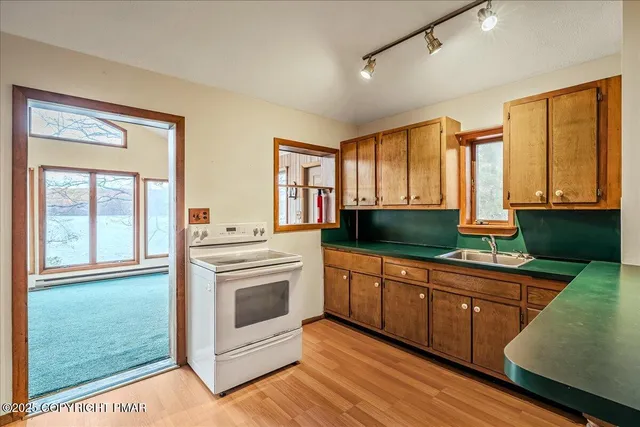 a kitchen with granite countertop a stove and a sink