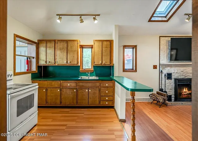 a kitchen with stainless steel appliances granite countertop a stove and a sink