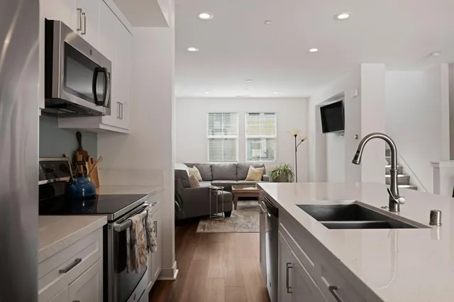 a kitchen that has a sink and a stove top oven