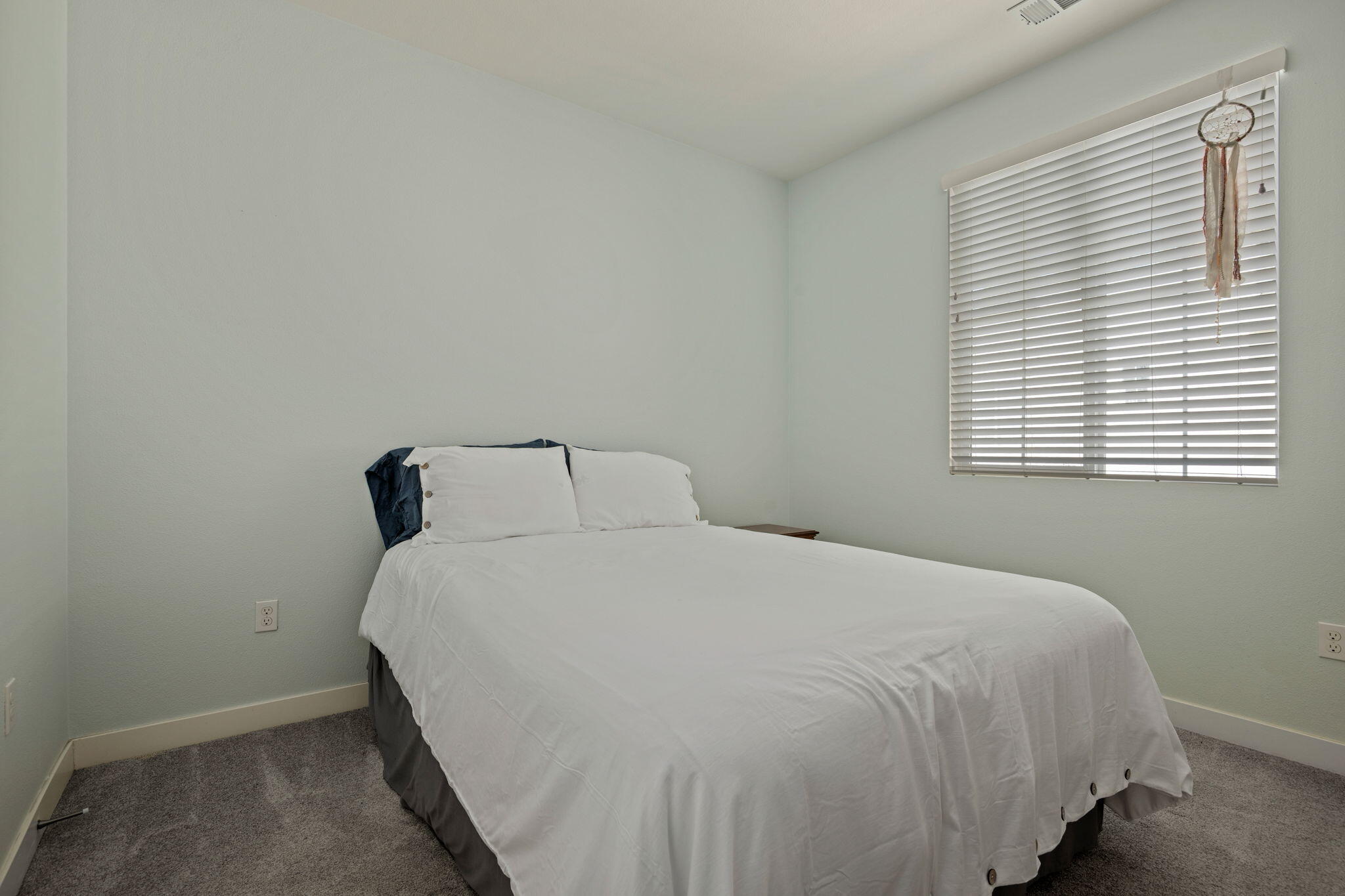 507 Bolinas Way, Unit 103 Goleta, CA 93117 - Photo 17 of 28 a large bed sitting in a bedroom next to a window