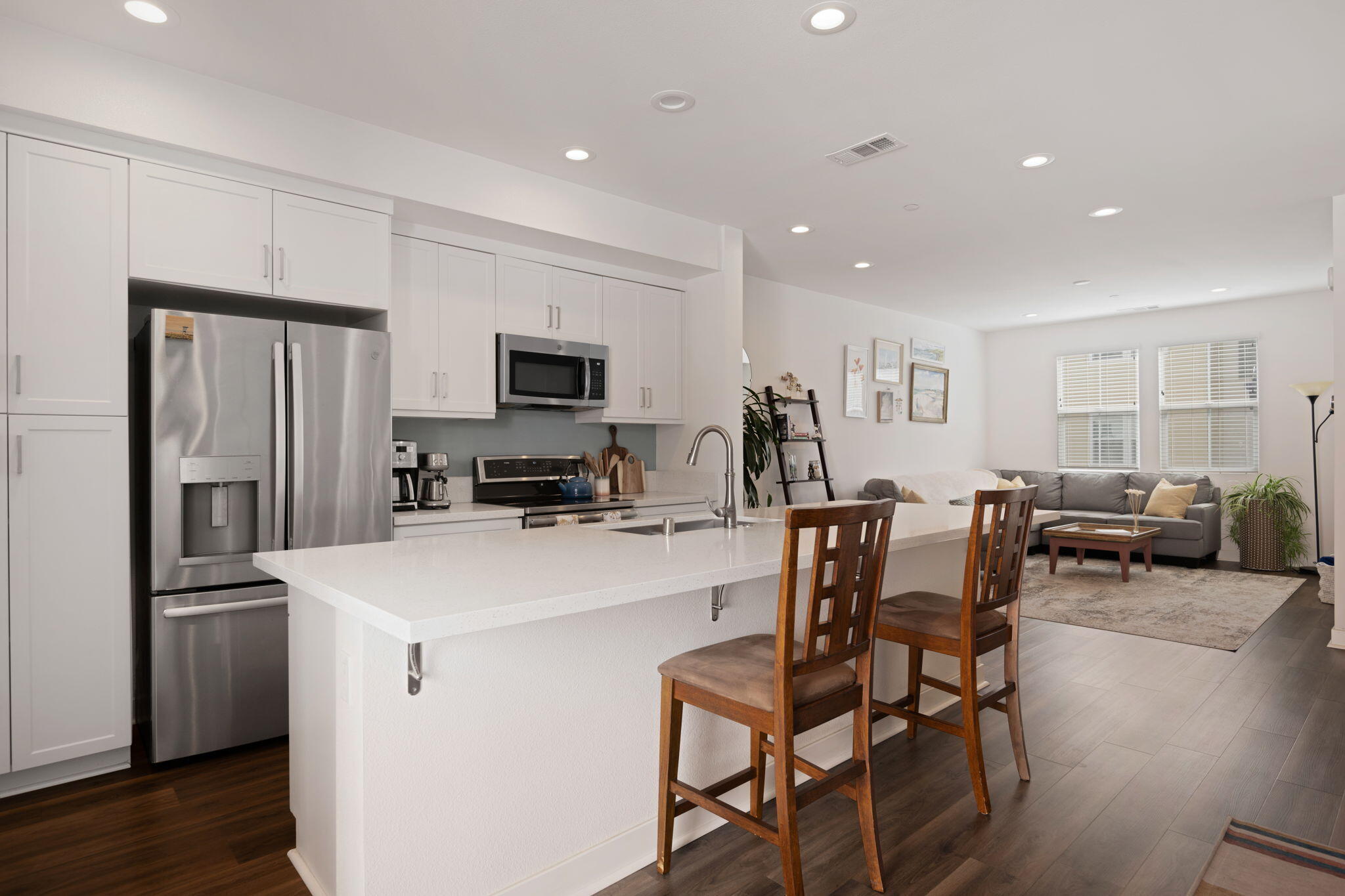 507 Bolinas Way, Unit 103 Goleta, CA 93117 - Photo 5 of 28 a kitchen with a refrigerator a stove a dining table and chairs