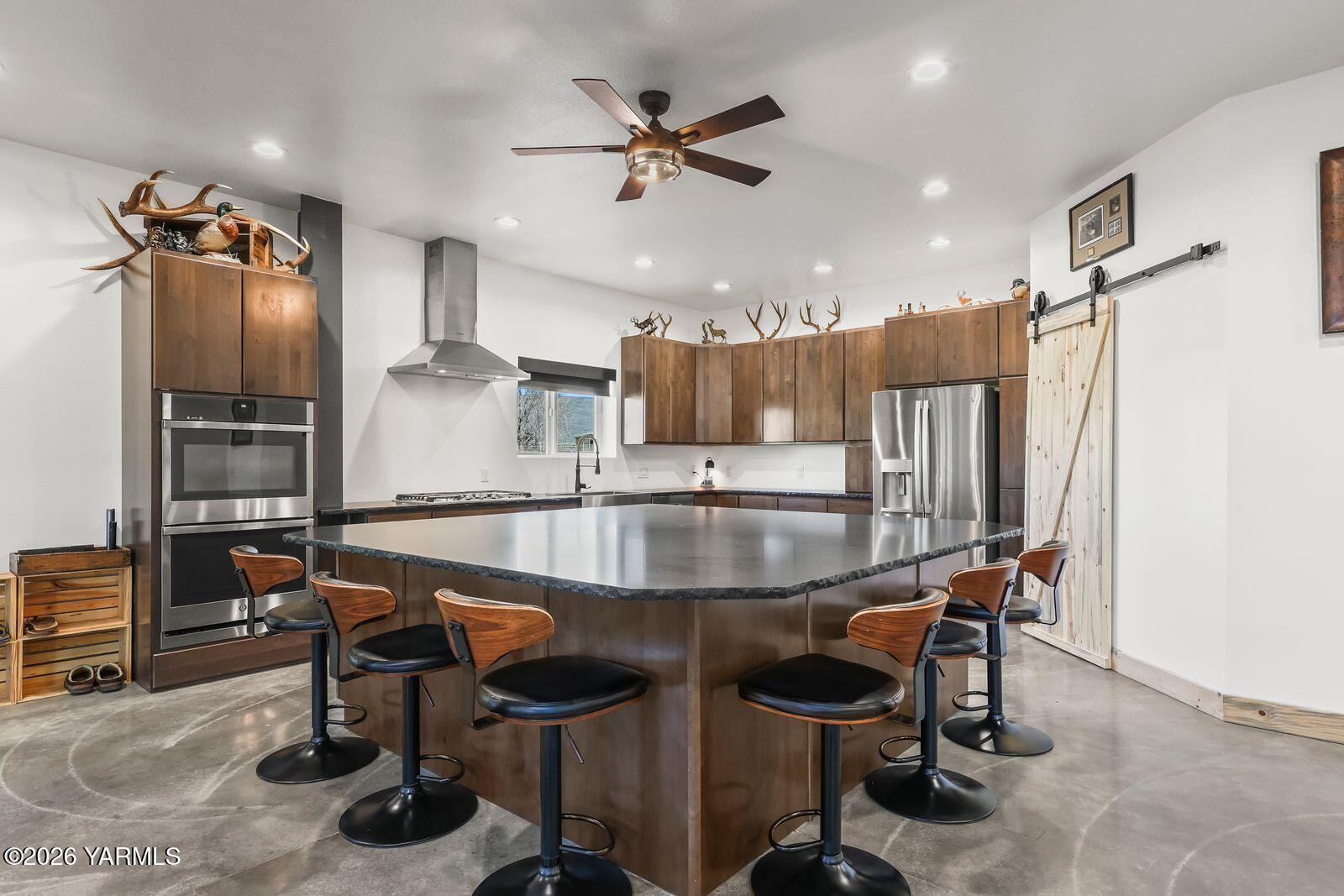 190 Gopher Road Selah, WA 98942 - Photo 8 of 48 a kitchen with a table chairs refrigerator and cabinets