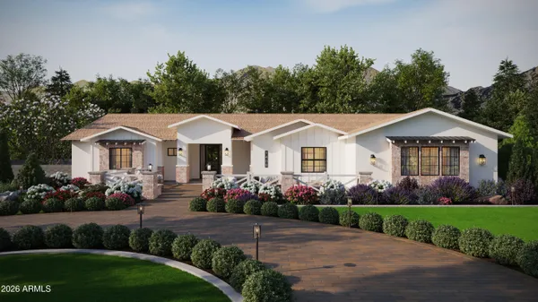 a front view of a white house with a yard