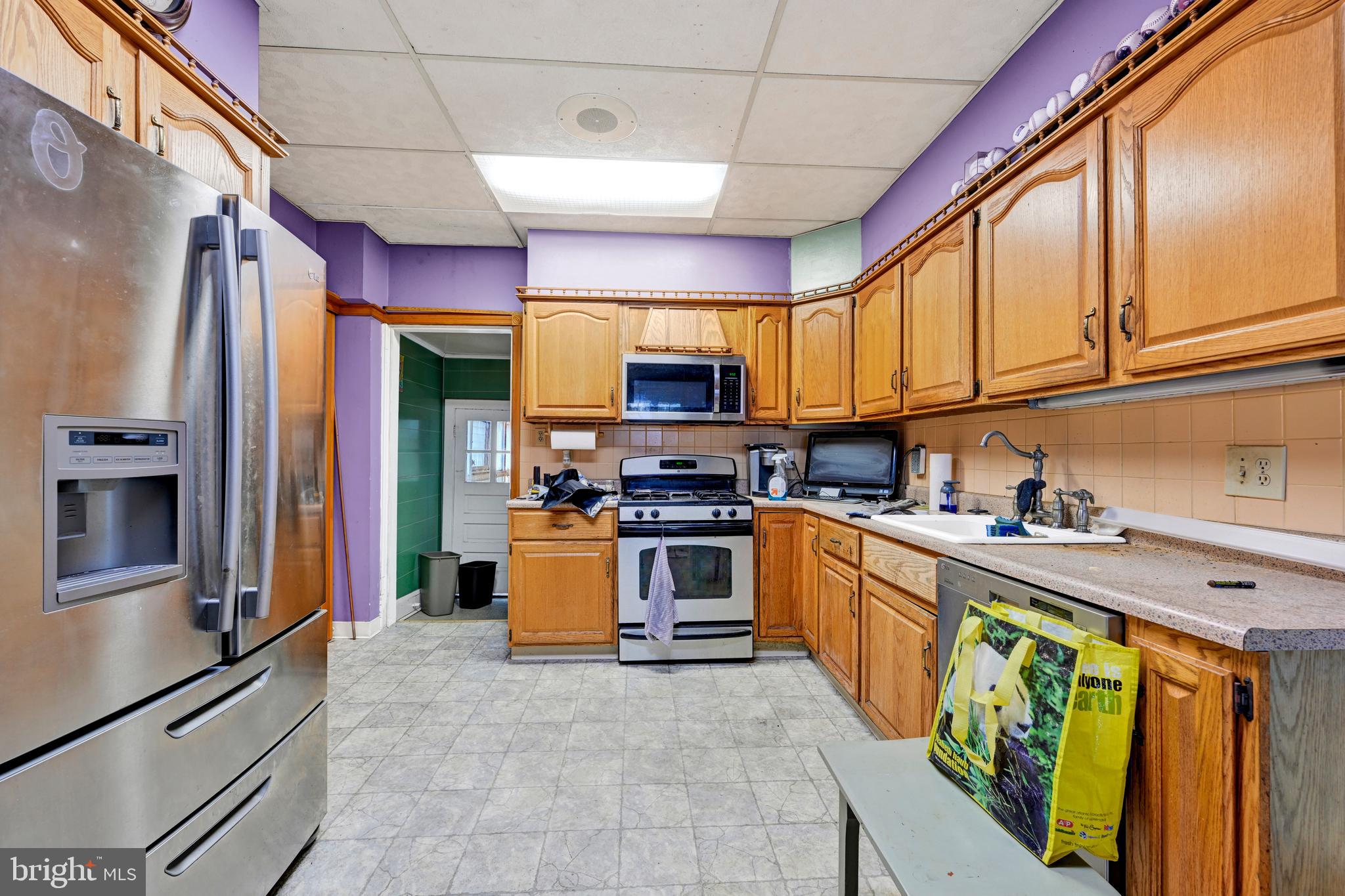 6500 Old Harford Road Baltimore, MD 21214 - Photo 11 of 28 a kitchen with stainless steel appliances granite countertop a refrigerator and a stove top oven