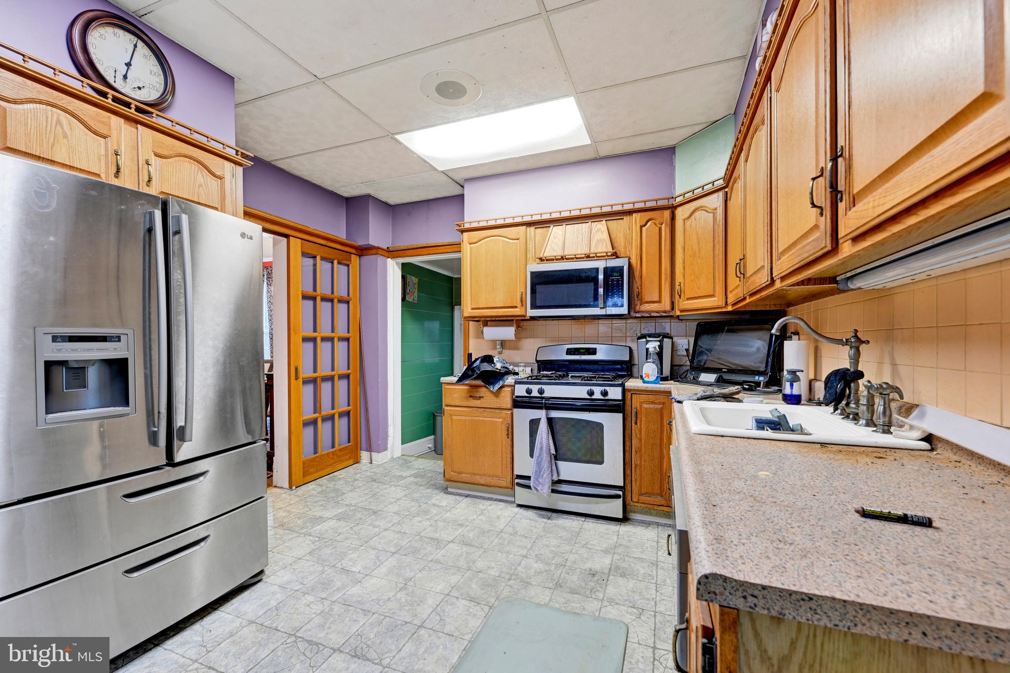 6500 Old Harford Road Baltimore, MD 21214 - Photo 12 of 28 a kitchen with stainless steel appliances granite countertop a refrigerator a stove top oven a sink and dishwasher
