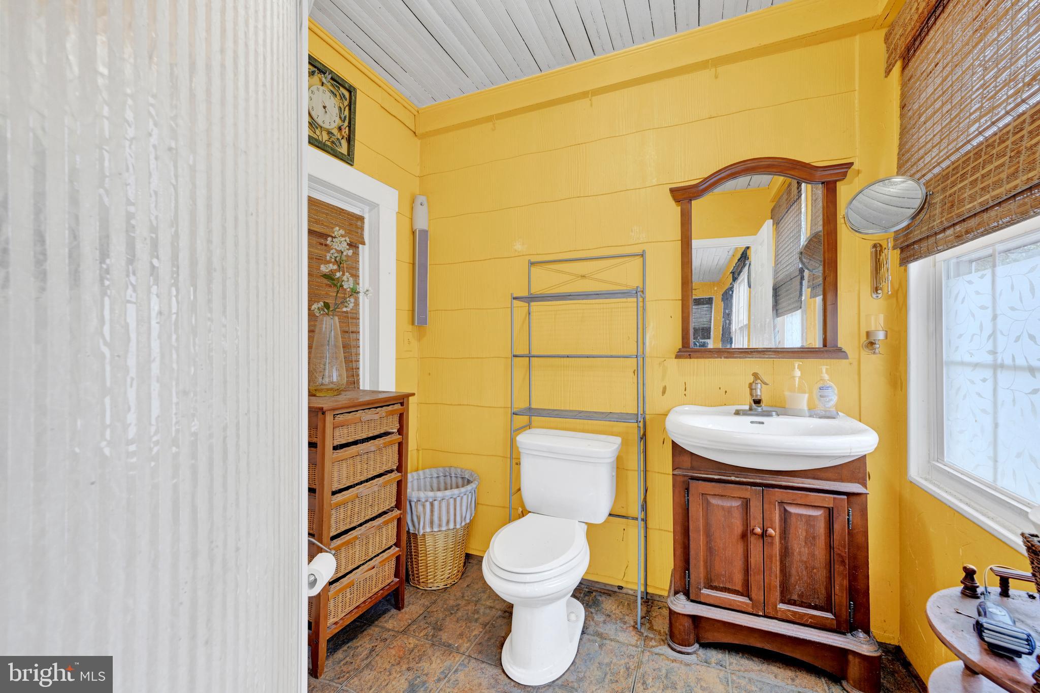 6500 Old Harford Road Baltimore, MD 21214 - Photo 21 of 28 a bathroom with a granite countertop toilet sink and mirror