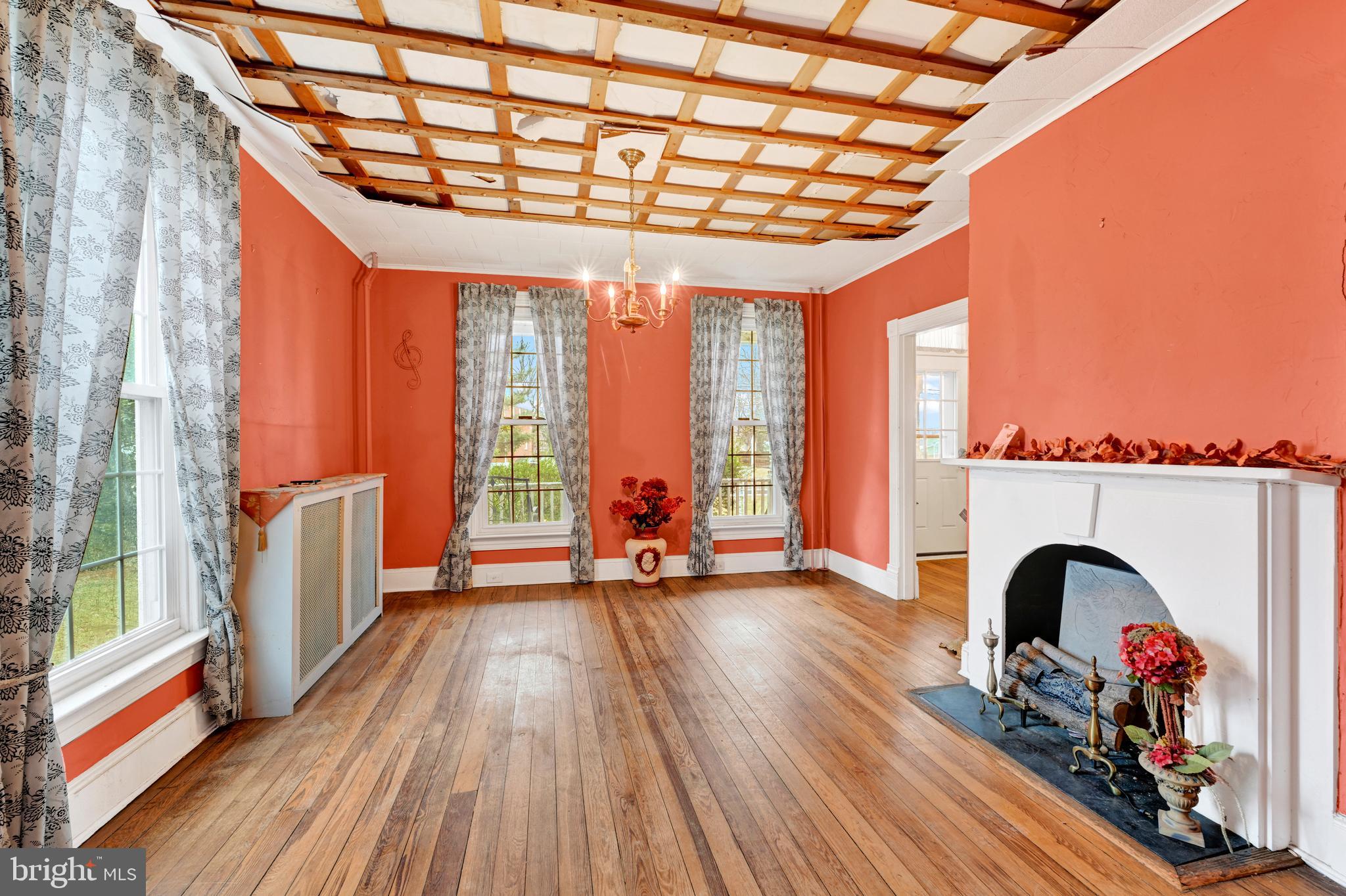 6500 Old Harford Road Baltimore, MD 21214 - Photo 9 of 28 a view of empty room with wooden floor and fireplace